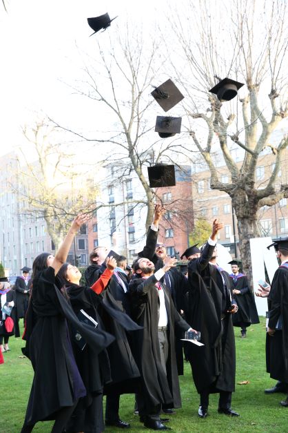 a picture of graduates throwing their caps